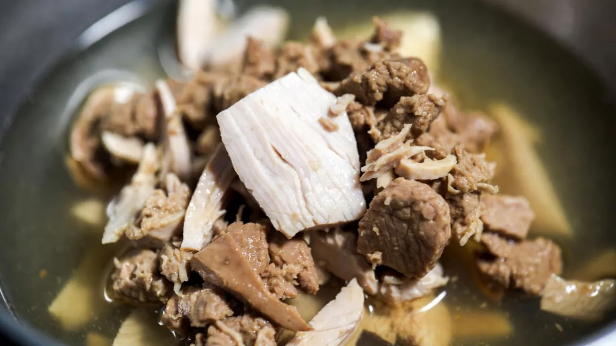 Blue Buffalo Wilderness chicken wet food showing hearty flaked meat texture.